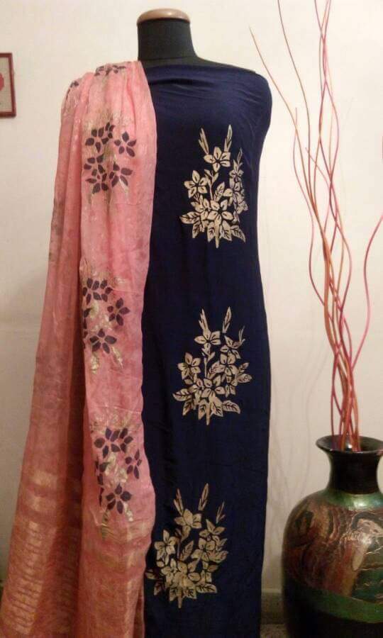 Hand-painted floral design on a dark fabric suit