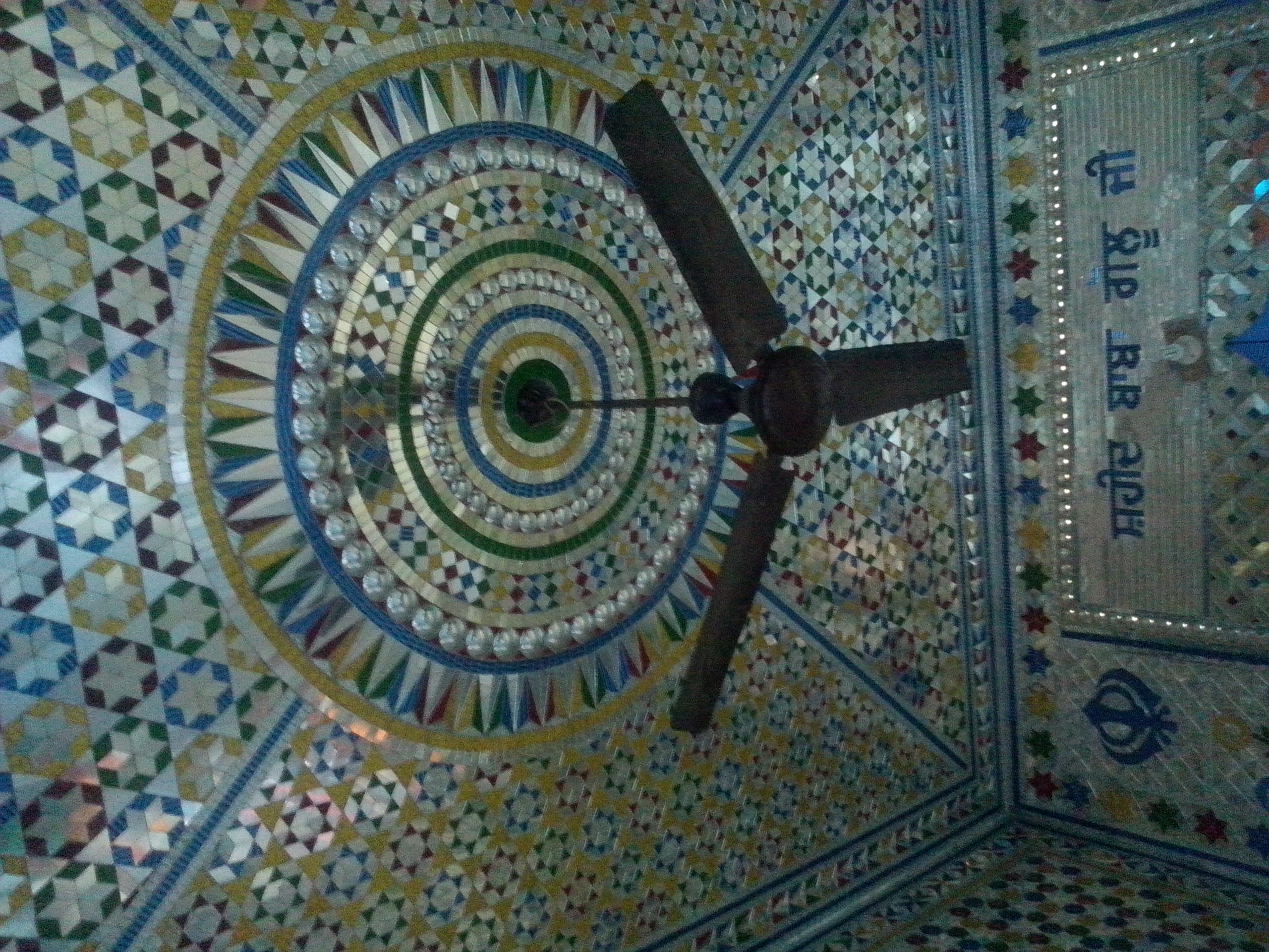 Intricate circular mosaic pattern on an ornamental ceiling