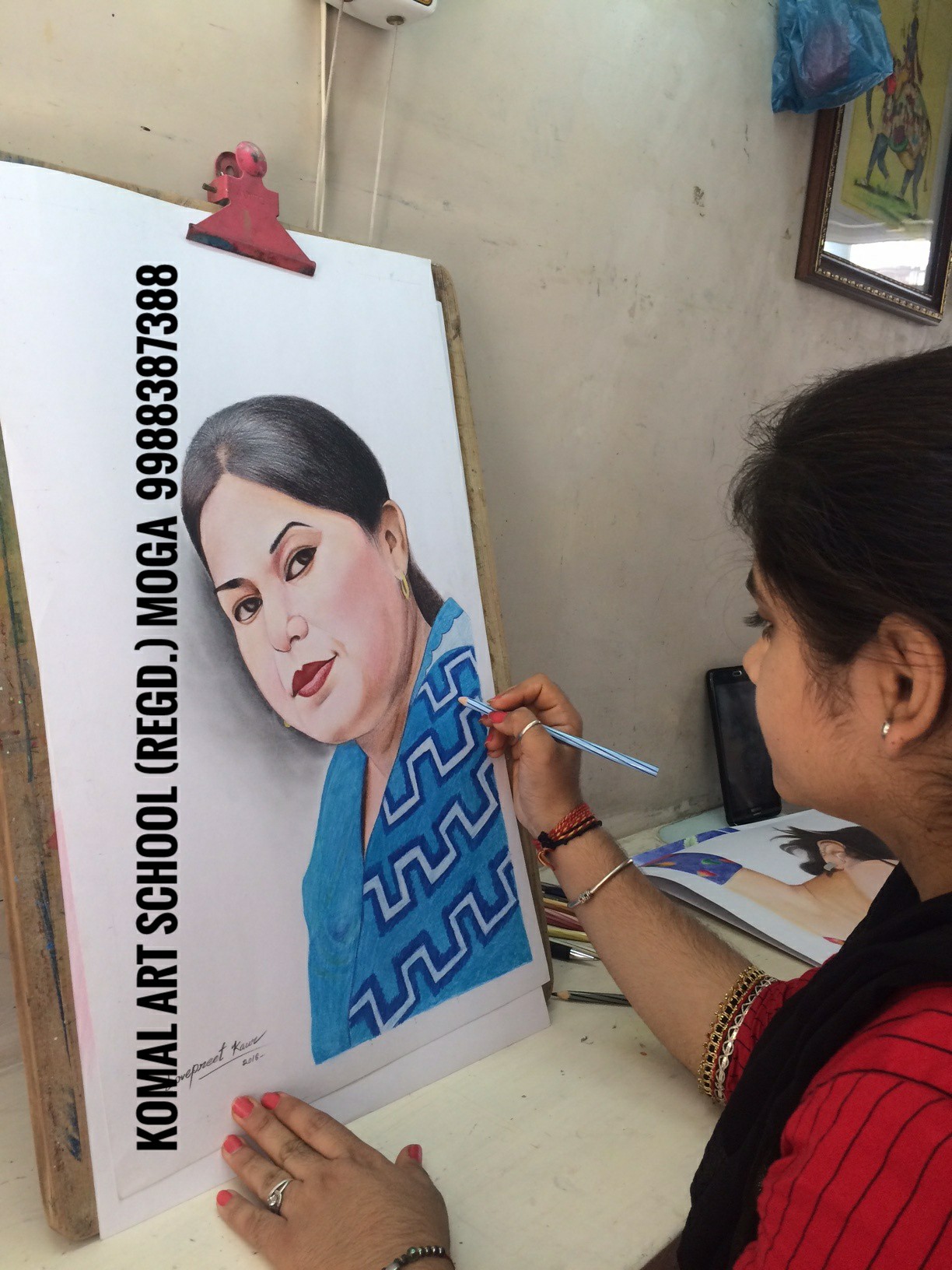 Student painting a portrait on a large canvas