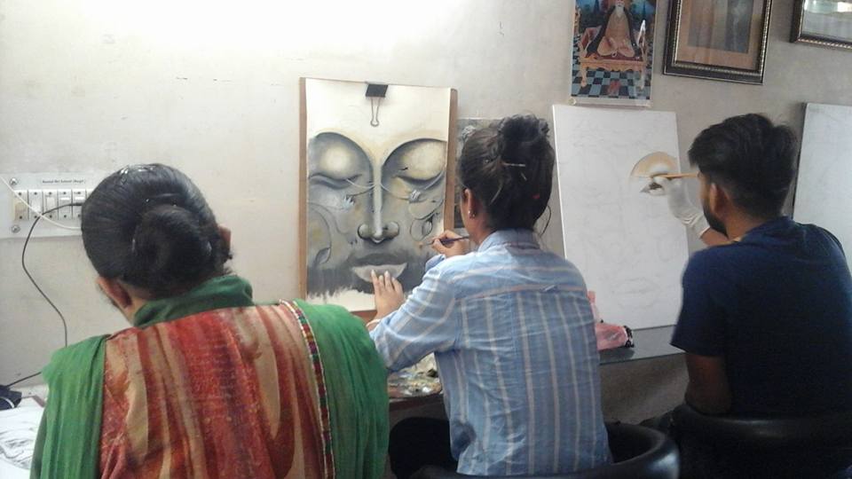 Students working together on paintings in the studio